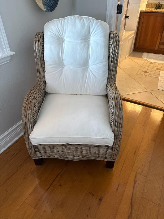 Wicker accent chair with white cushions from a Phoenix estate furniture purchase