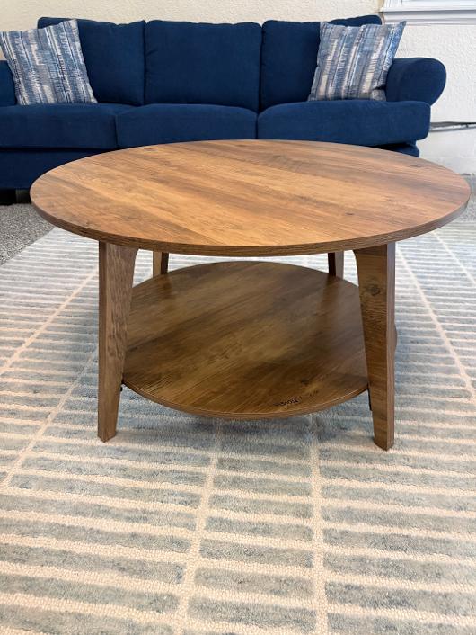 Round wood coffee table with shelf purchased with blue sofa in Phoenix